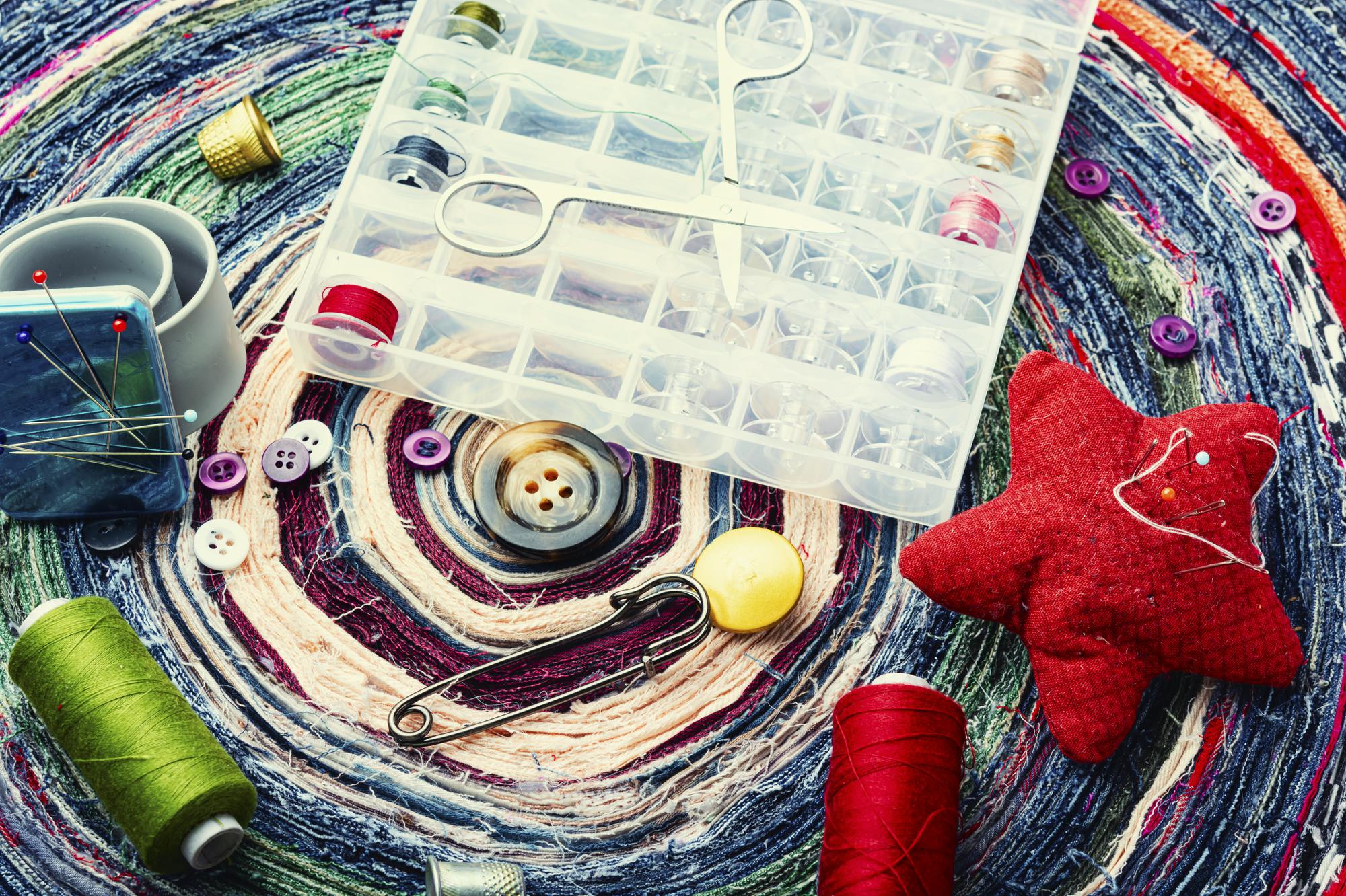 flatlay of threads, needles and stitched patches